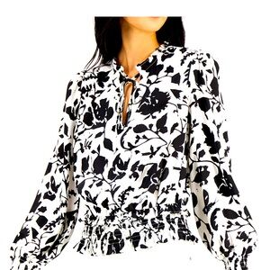 Smocked details and lovely print turn up the polished style on this peasant top